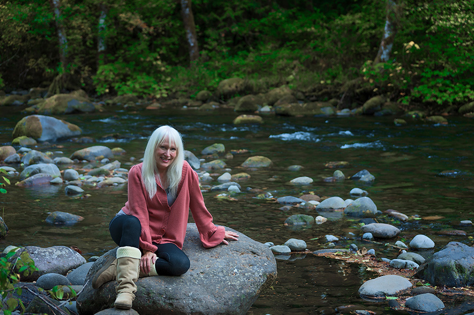 Discover stunning open spaces in the Pacific Northwest by rail with Amtrak Vacations Woman sitting in a creek in the Pacific Northwest
