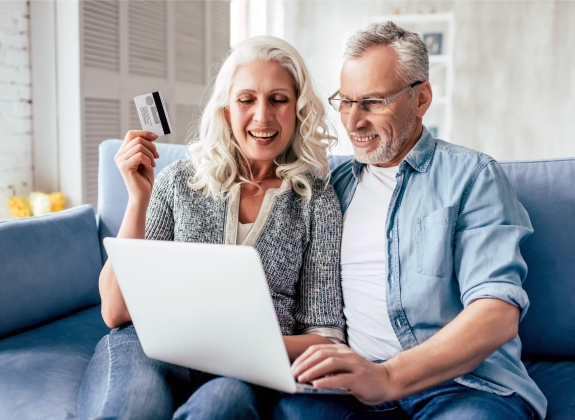 Mature couple looking at computer screen at home